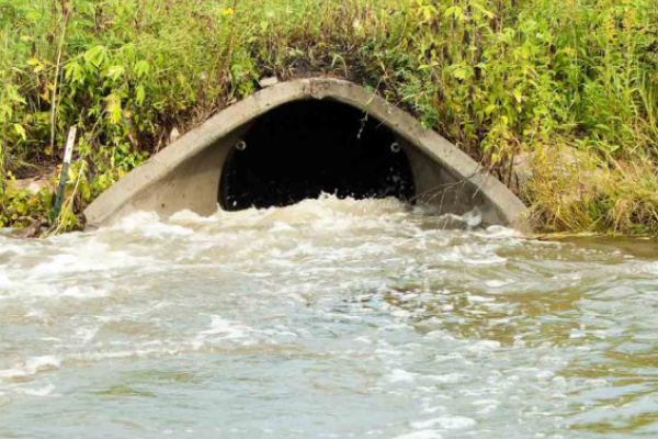 A storm drain filling up with water. 