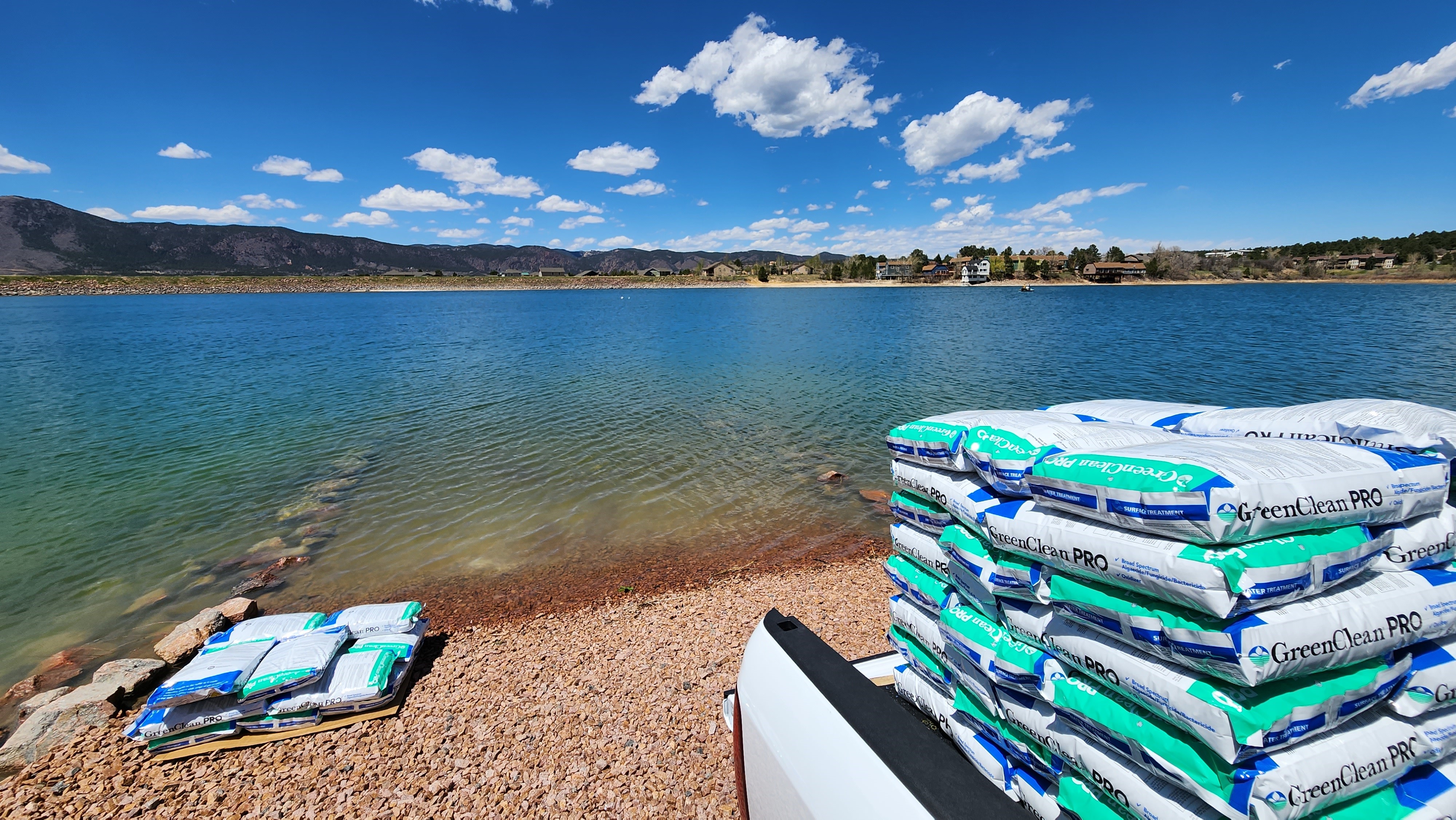 A body of water with big white bags next to it.
