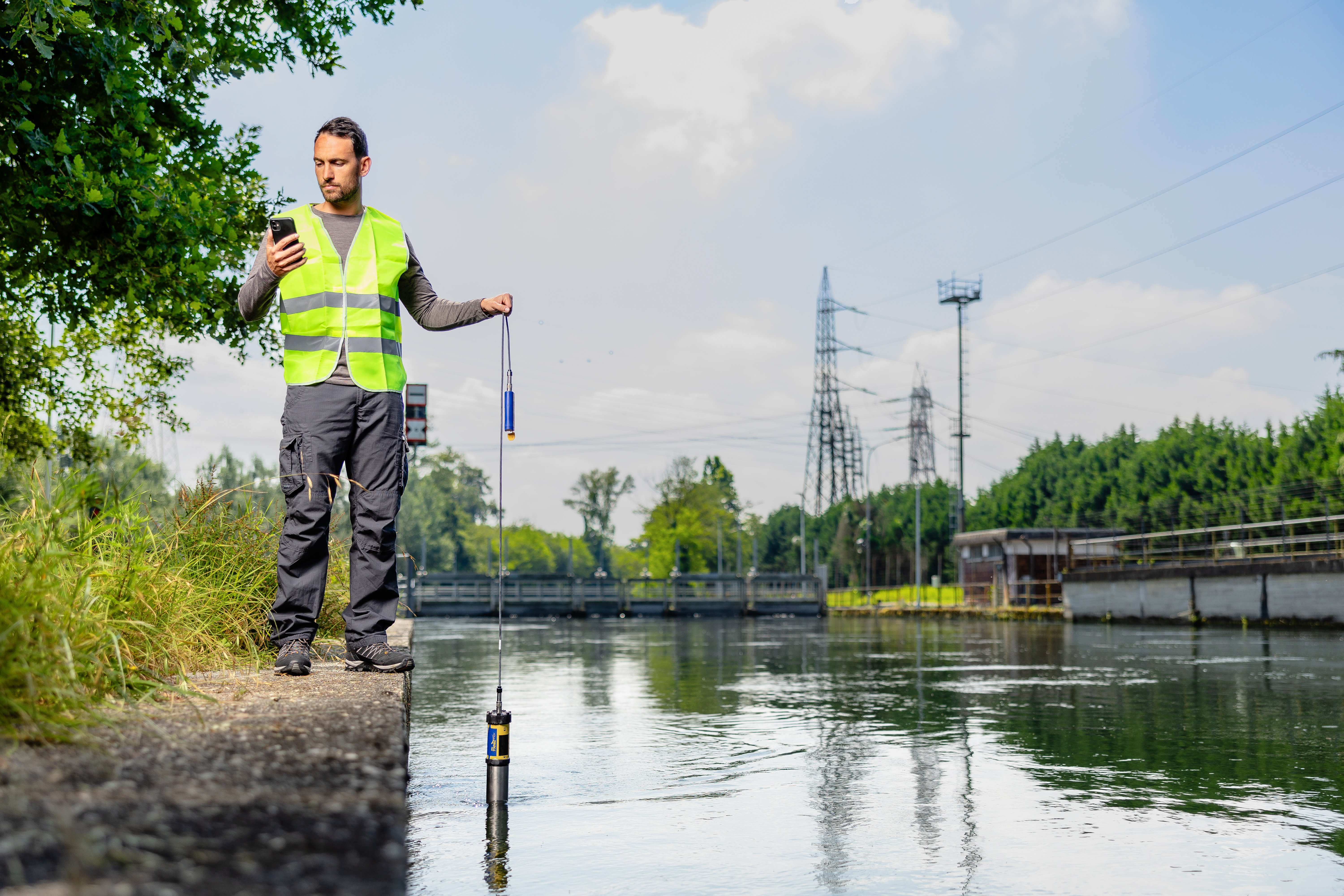 A man in workers vest measuring water parameter
